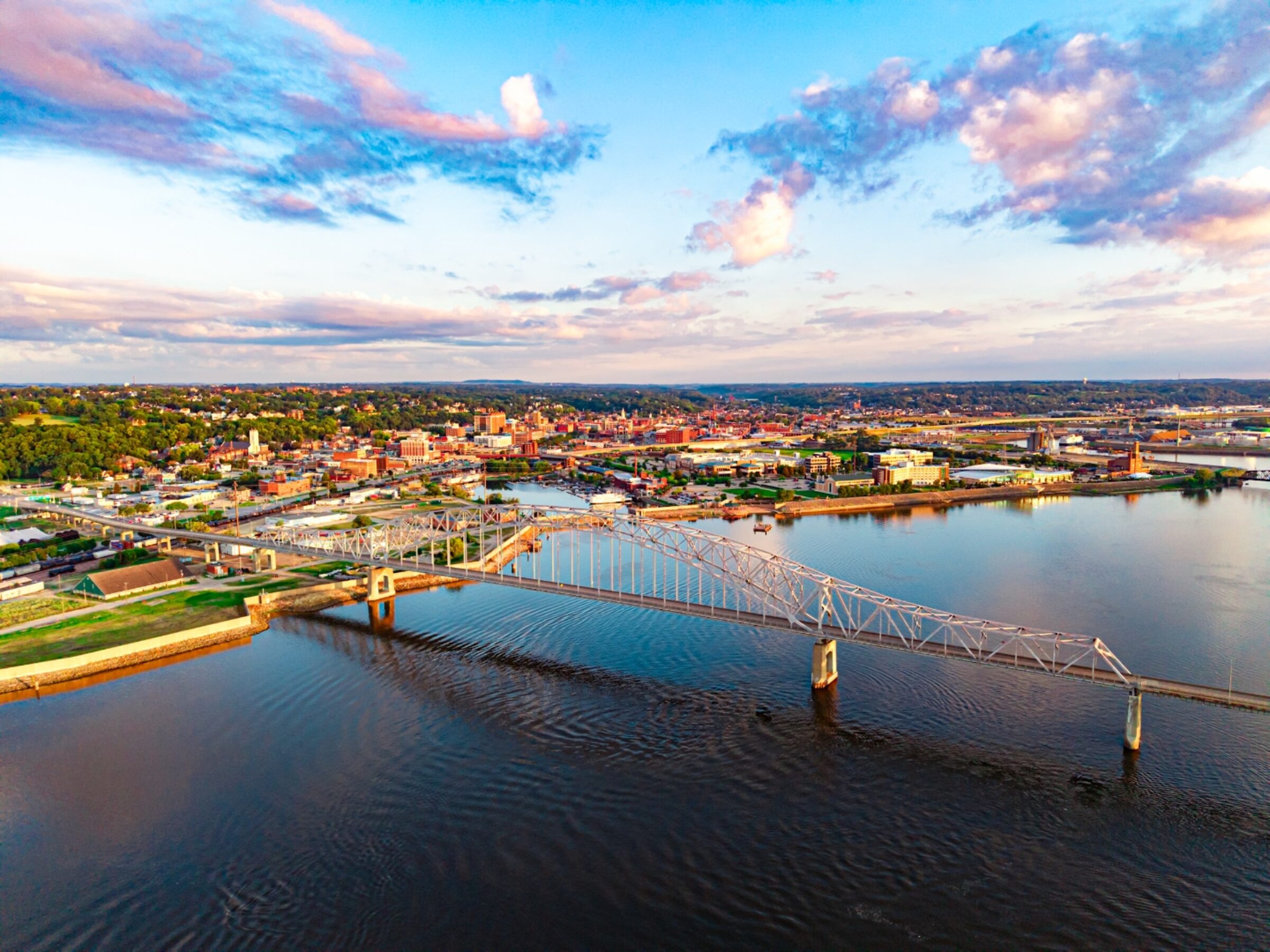 Julien Dubuque Bridge over the Mississippi River at golden hour, aerial view